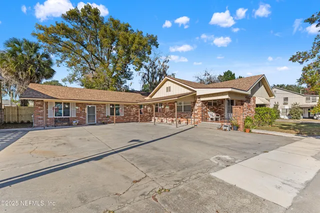 a front view of a house with a garden and pathway