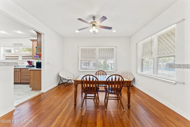 a view of a dining room with furniture window and wooden floor