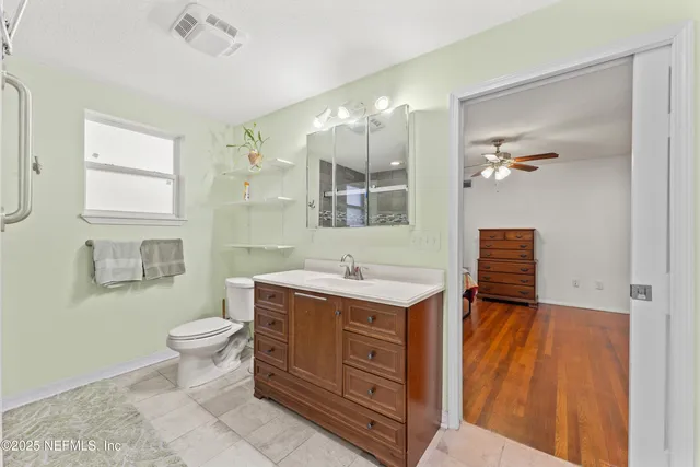 a bathroom with a sink a toilet and mirror