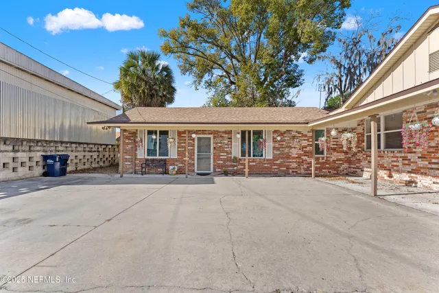 a front view of a house with basket ball court and outdoor seating