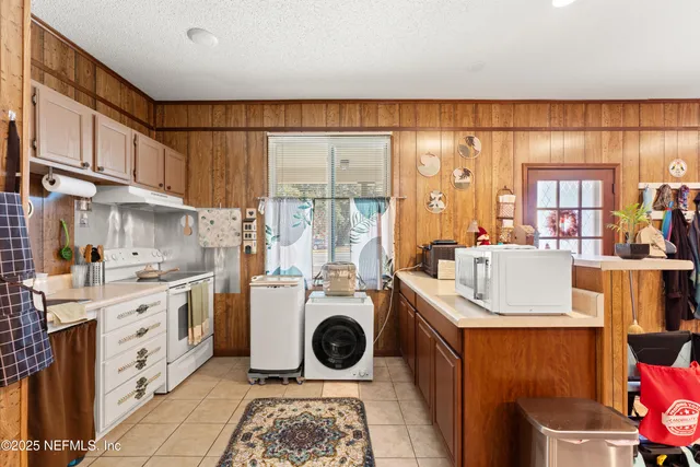 a kitchen with a stove a sink and a refrigerator