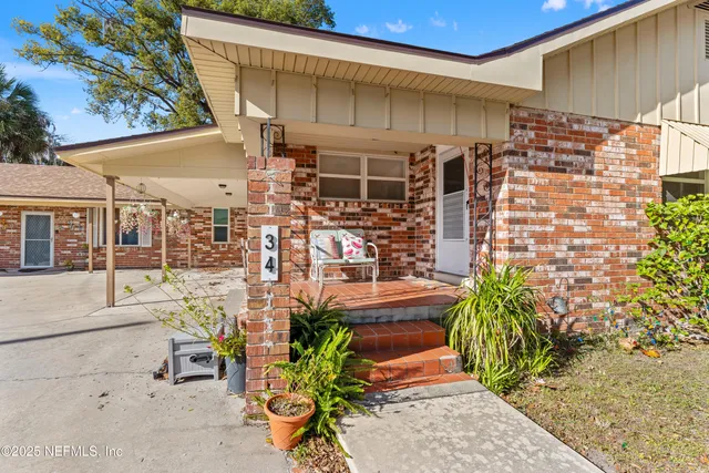 a view of a patio with table and chairs and potted plants