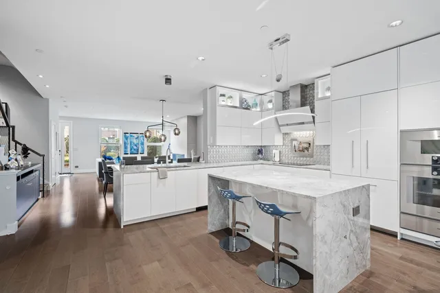 a kitchen with cabinets and wooden floor