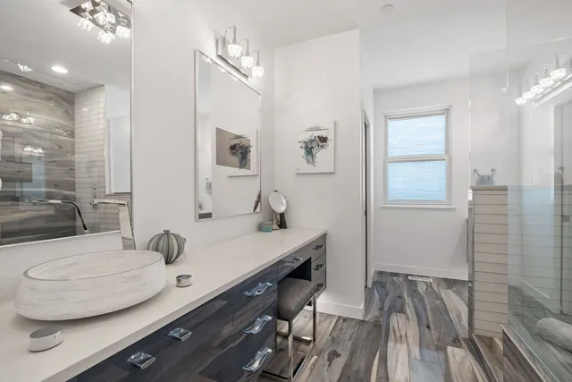 a bathroom with a sink a toilet and shower