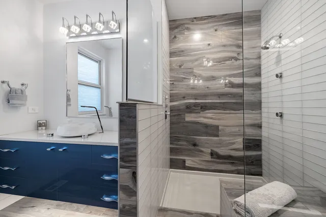 a bathroom with a shower sink and mirror