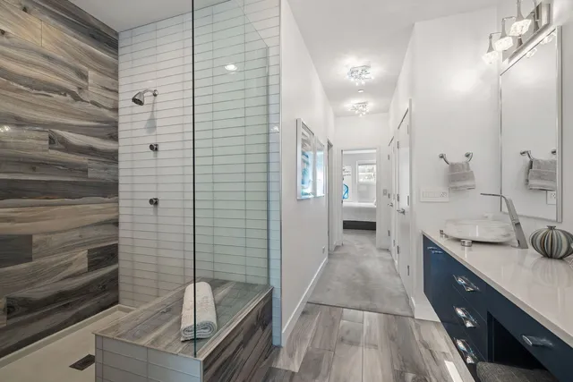 a bathroom with a sink a mirror and shower