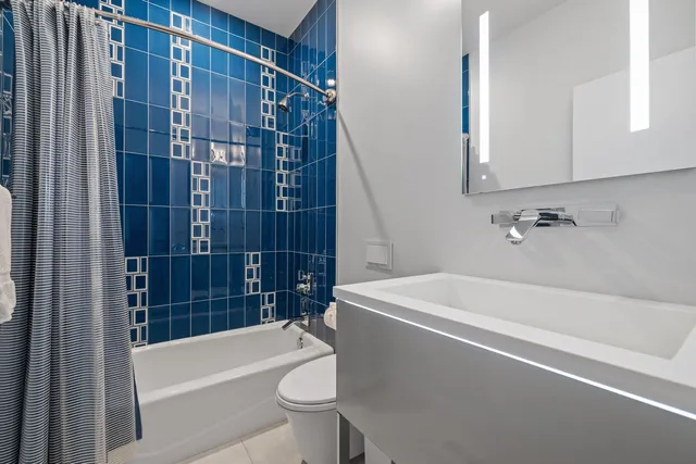 a white bath tub sitting next to a white toilet