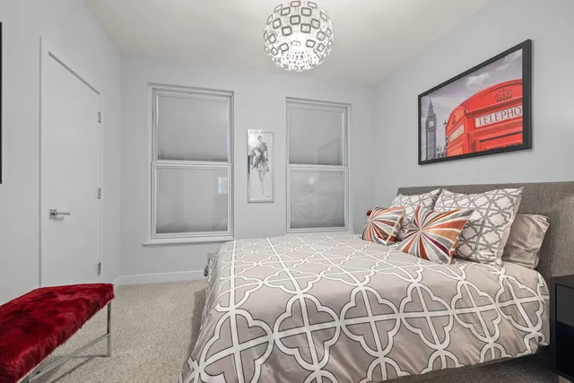 a bedroom with a bed and a painting on the wall