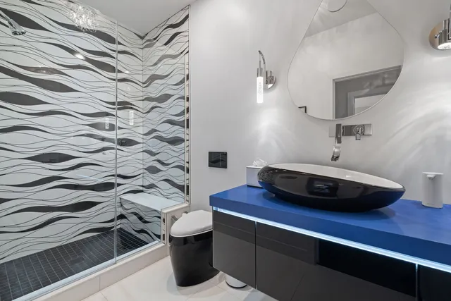 a room with a sink and a mirror