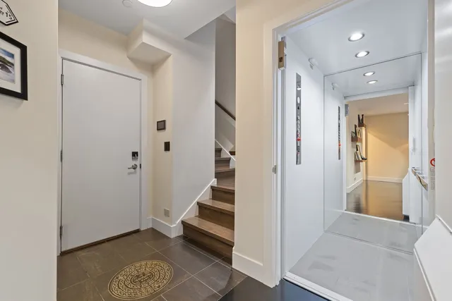 a view of a hallway with wooden floor and entryway