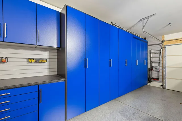 a view of a kitchen with wooden cabinets and a refrigerator
