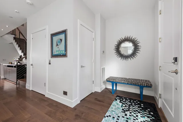 a view of a hallway with workspace and a window