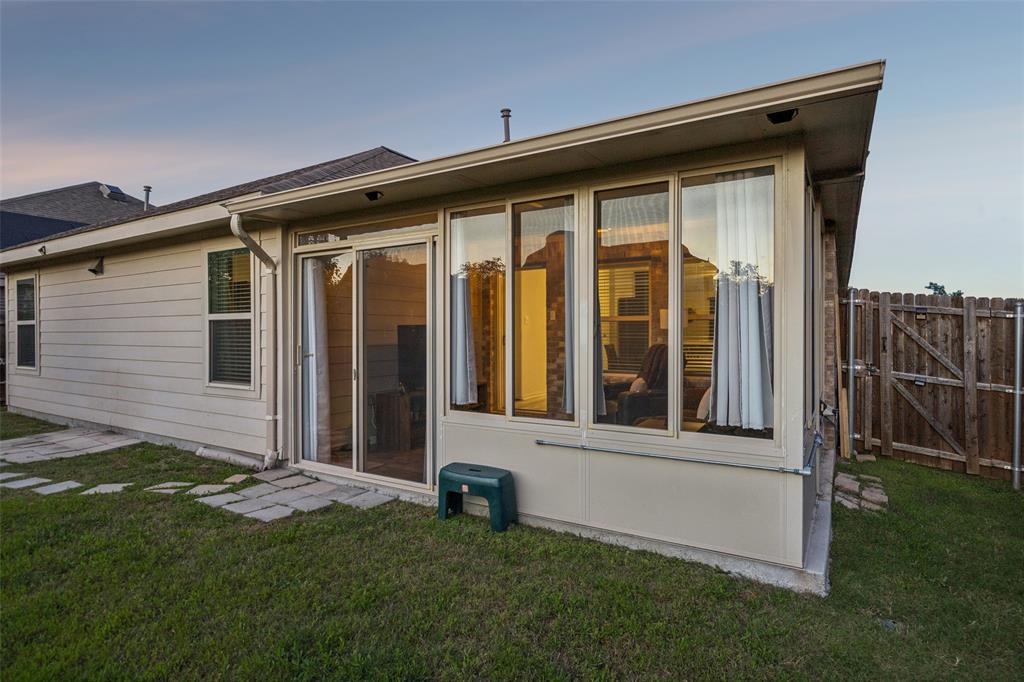 406 Madrone Lane Princeton, TX 75407 - Photo 23 of 30 Rear exterior featuring an enclosed patio with large windows and a sliding glass door