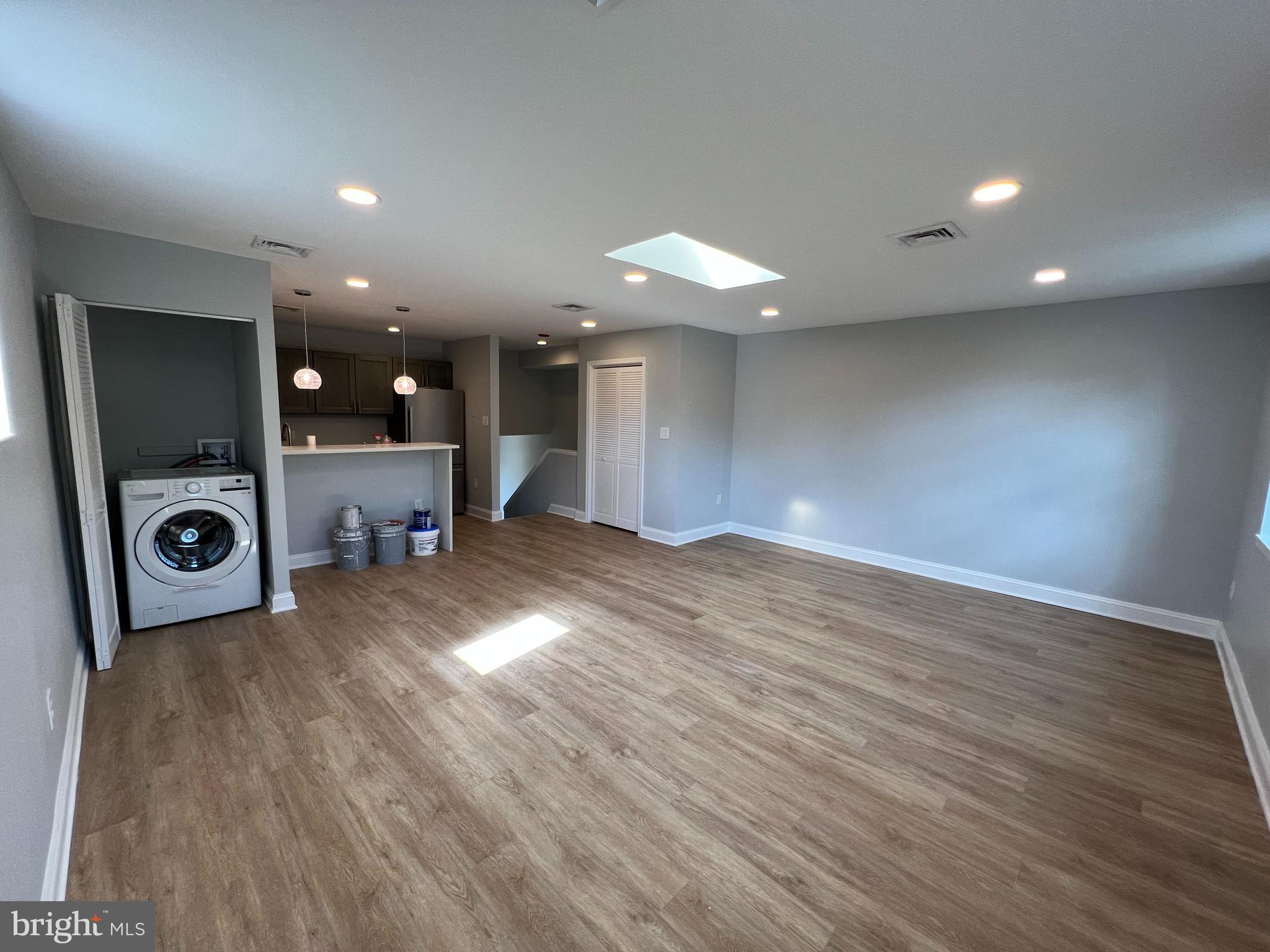 1939 Mt Vernon Street, Unit 3 Philadelphia, PA 19130 - Photo 3 of 17 an empty room with wooden floor and a bathroom