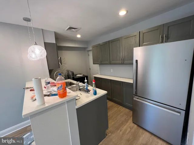 a kitchen with a refrigerator and a sink