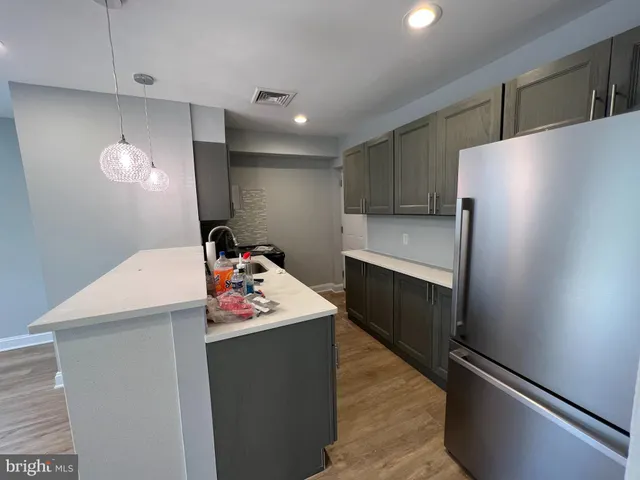 a utility room with cabinets washer and dryer