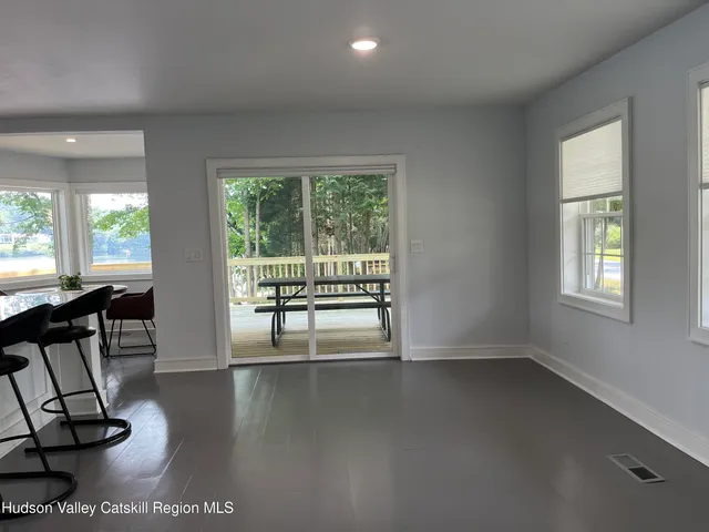 a view of room with window and wooden floor