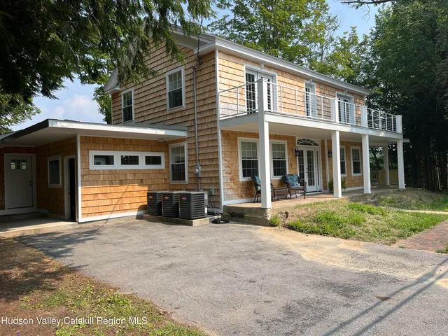 a front view of a house with a yard and glass windows