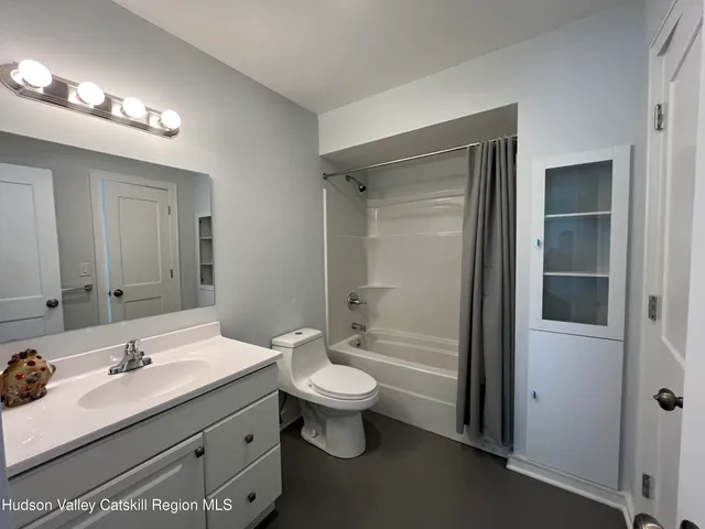 a bathroom with a double vanity sink toilet and shower