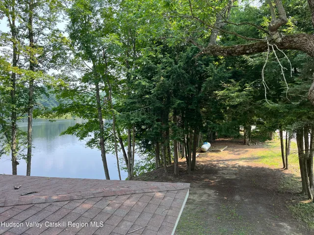 a view of a wooden chairs on the roof deck