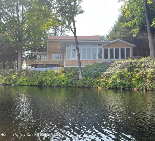 a front view of a house with a lake view