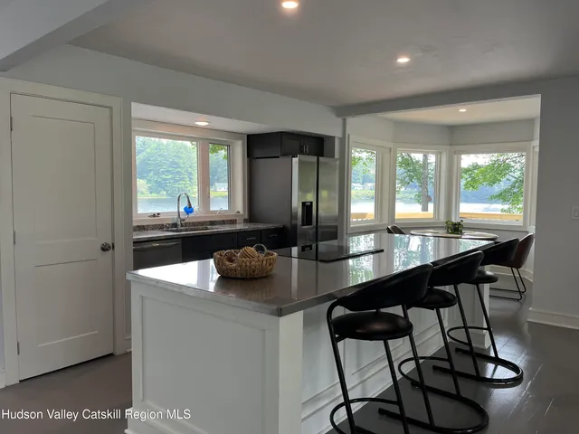 a kitchen with a table chairs and couches