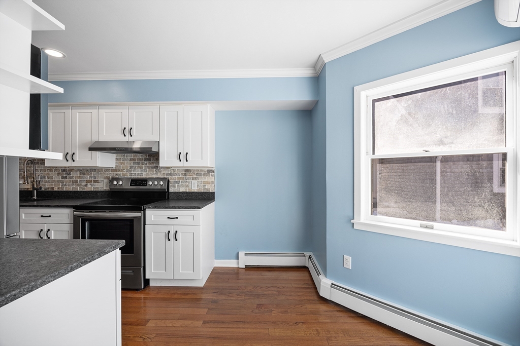 30 Commodore Court, Unit 30 Hull, MA 02045 - Photo 11 of 42 a kitchen with granite countertop white cabinets and a window