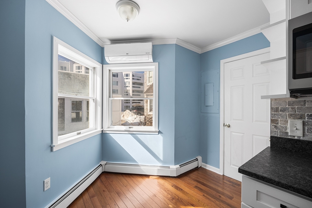 30 Commodore Court, Unit 30 Hull, MA 02045 - Photo 12 of 42 a view of an empty room with a window and wooden floor