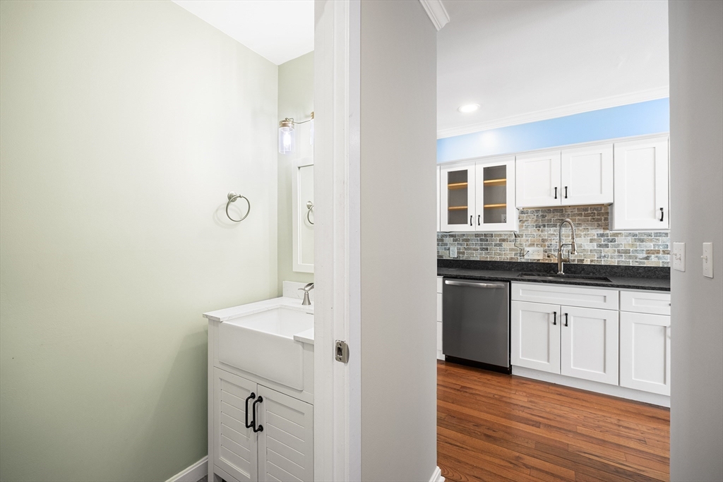 30 Commodore Court, Unit 30 Hull, MA 02045 - Photo 13 of 42 a bathroom with a granite countertop sink mirror and cabinets