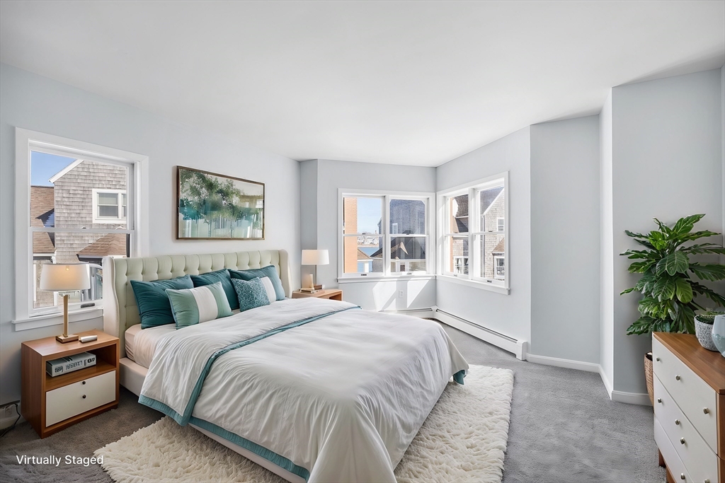 30 Commodore Court, Unit 30 Hull, MA 02045 - Photo 15 of 42 a bedroom with a large bed and a potted plant