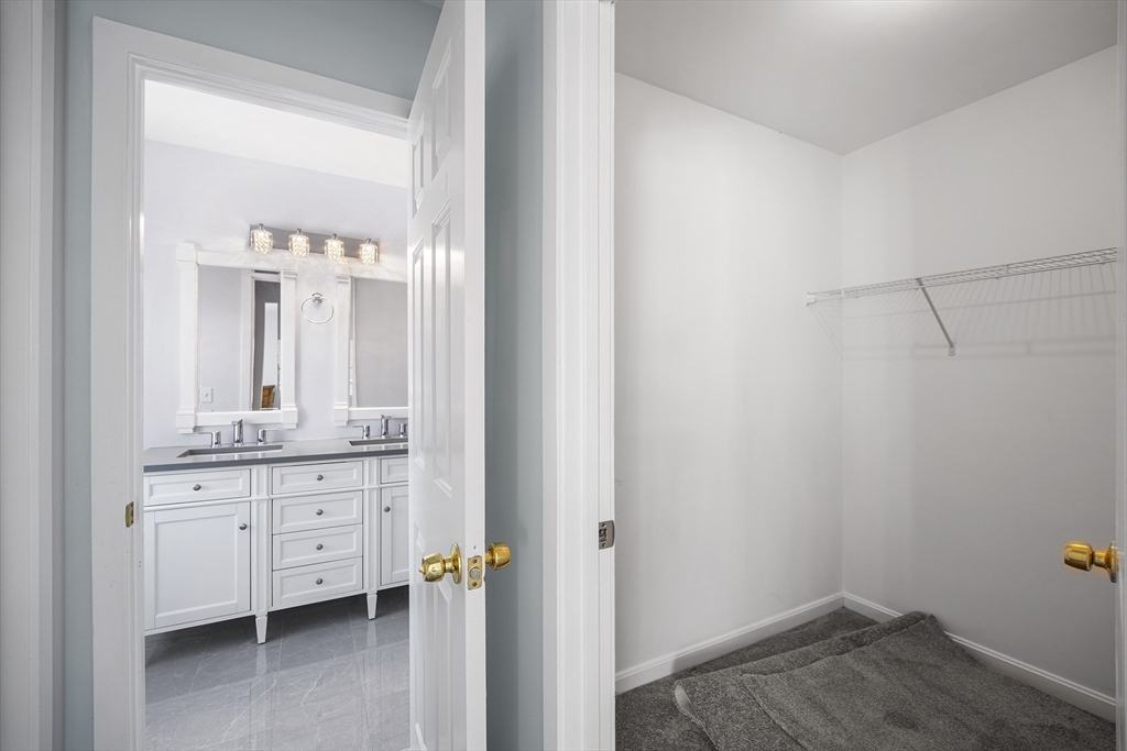 30 Commodore Court, Unit 30 Hull, MA 02045 - Photo 18 of 42 a bathroom with a granite countertop sink a toilet and a mirror