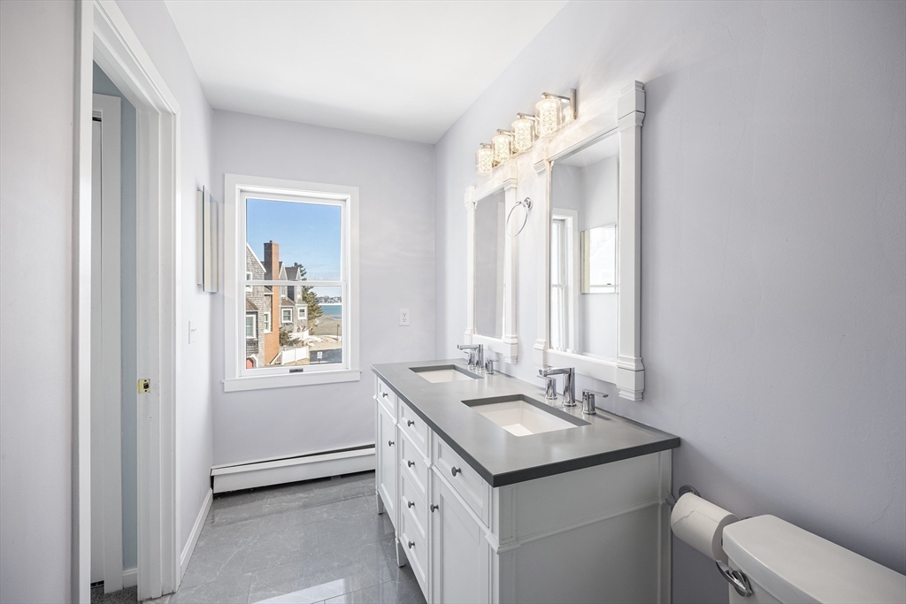 30 Commodore Court, Unit 30 Hull, MA 02045 - Photo 19 of 42 a bathroom with a sink vanity granite and a toilet
