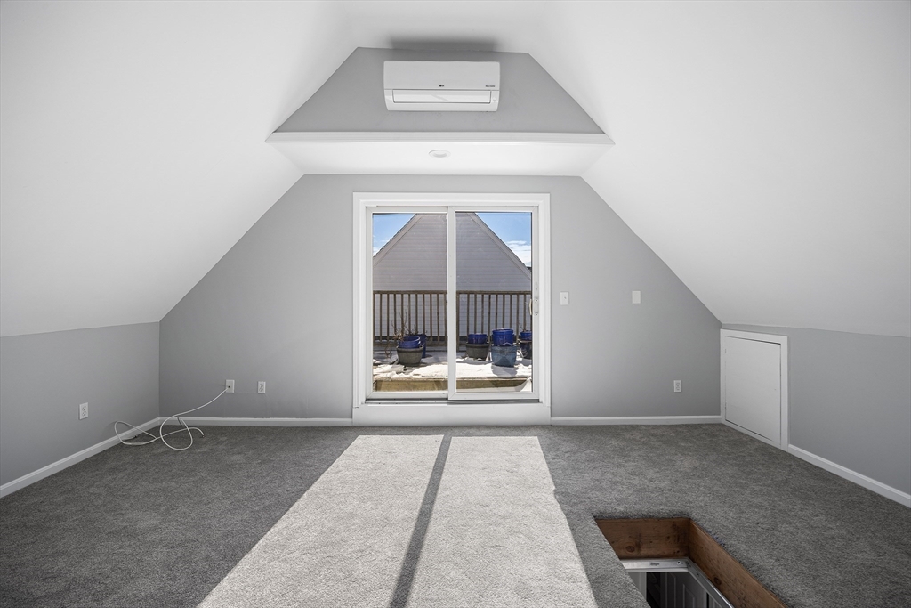 30 Commodore Court, Unit 30 Hull, MA 02045 - Photo 25 of 42 an empty room with a fireplace and windows