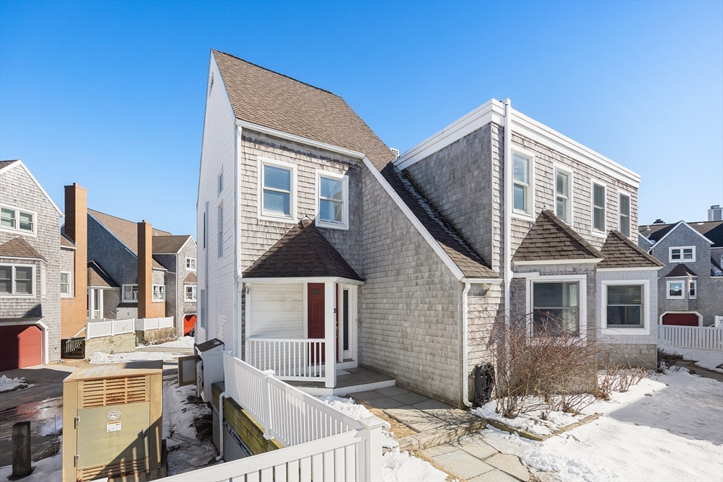 30 Commodore Court, Unit 30 Hull, MA 02045 - Photo 27 of 42 a front view of a house with a yard