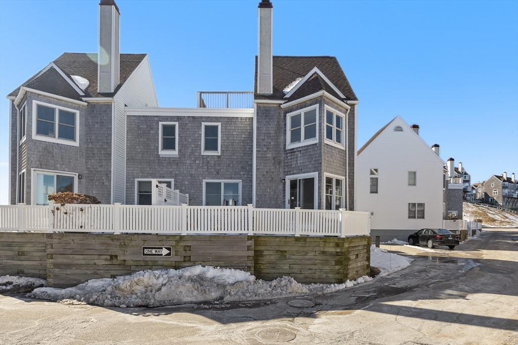 30 Commodore Court, Unit 30 Hull, MA 02045 - Photo 28 of 42 a front view of a house with a yard