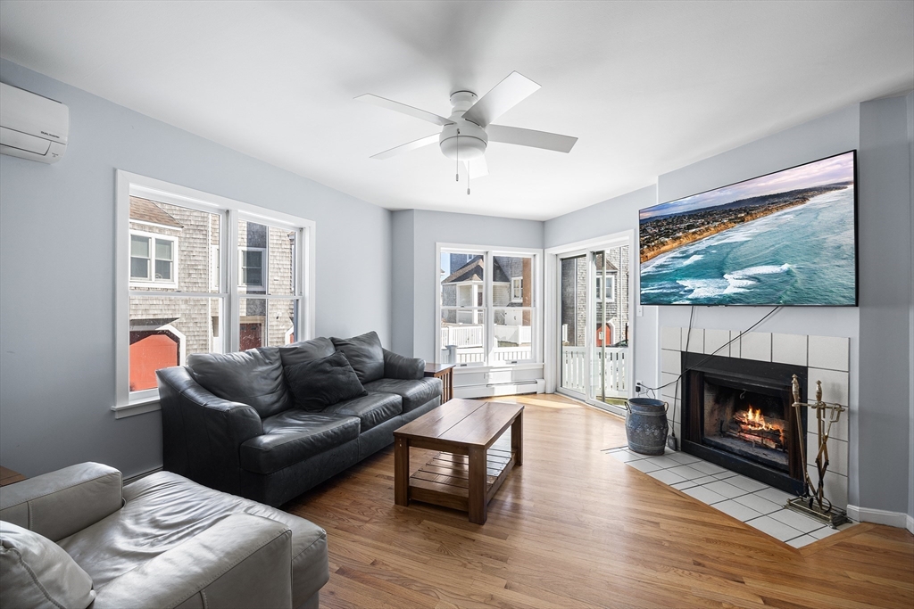30 Commodore Court, Unit 30 Hull, MA 02045 - Photo 3 of 42 a living room with furniture and a fireplace