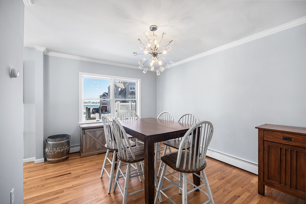 30 Commodore Court, Unit 30 Hull, MA 02045 - Photo 6 of 42 a view of a dining room with furniture and wooden floor