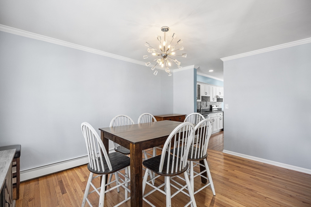 30 Commodore Court, Unit 30 Hull, MA 02045 - Photo 7 of 42 a view of a dining room with furniture and wooden floor