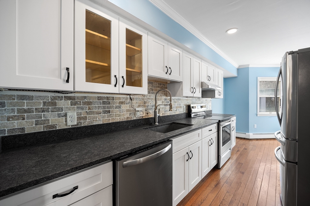30 Commodore Court, Unit 30 Hull, MA 02045 - Photo 10 of 42 a kitchen with stainless steel appliances granite countertop a sink stove and refrigerator