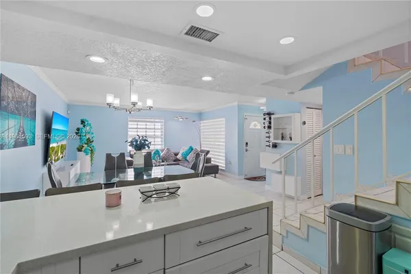 a view of living room with furniture and a chandelier