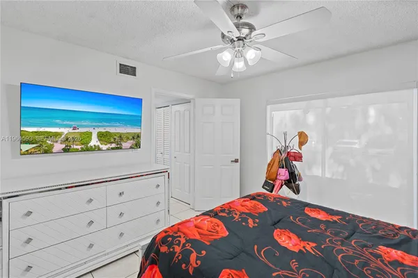 a bedroom with a bed and a dresser in it