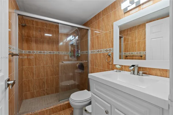 a bathroom with a sink toilet and shower