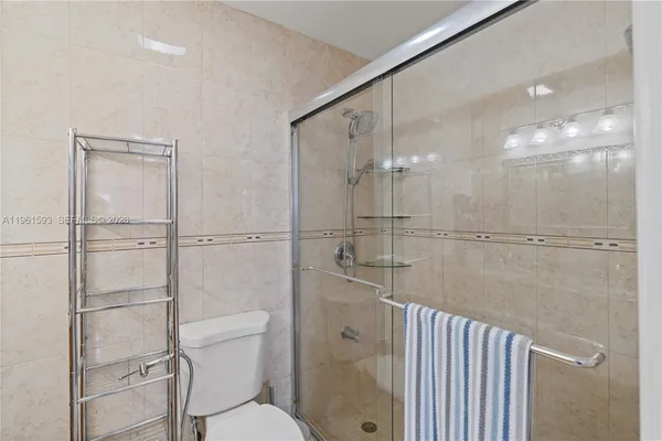 a bathroom with a shower and toilet