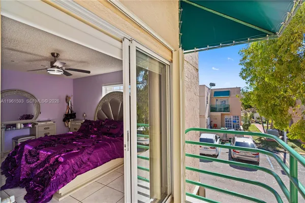 a view of balcony with furniture and a potted plant
