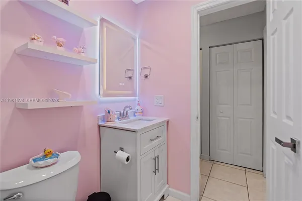a bathroom with a sink vanity and a mirror