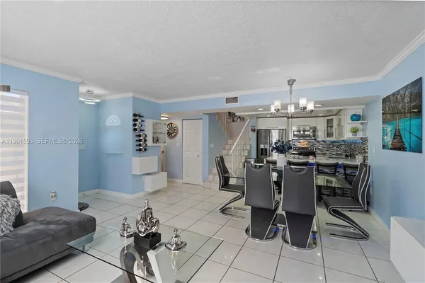 a living room with furniture and a chandelier
