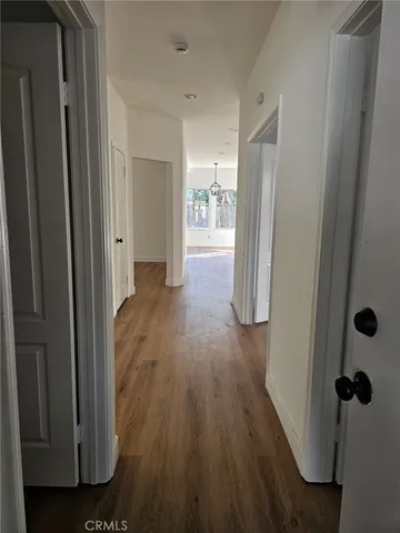 a view of hallway with wooden floor