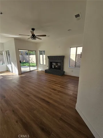 wooden floor in an empty room with a fireplace