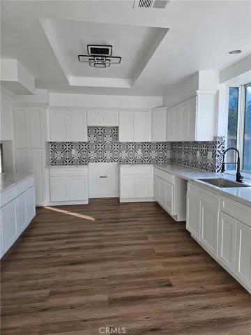 a kitchen with stainless steel appliances granite countertop a sink and cabinets