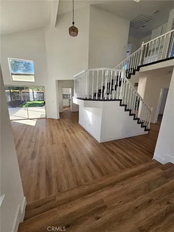 a view of entryway and hall with wooden floor